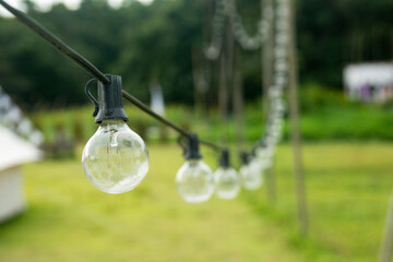 Outdoor string Light bulbs hanging on a line.