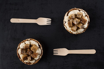 Two banofee high banana pie with wooden disposable fork