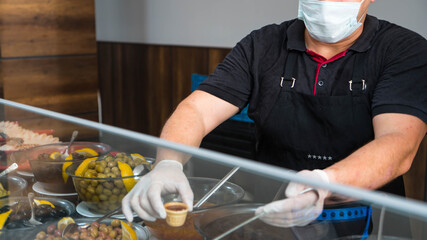 Food service in the hotel or restaurant. The chef prepares food in the restaurant and packs it in disposable dishes