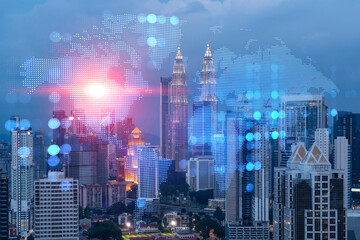 Hologram of Earth planet map on night panoramic cityscape of Kuala Lumpur, Malaysia, Asia. The...