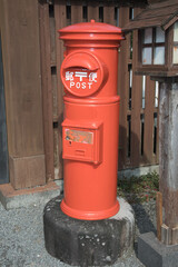 Fototapeta na wymiar Disused traditional Japanese post box, Shimabara, Japan. Japanese text translates as Post, which is also written in English
