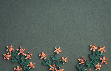 Beautiful flowers designs isolated on green paper background. Colorful paper flowers. Hand made of paper quilling technique