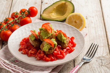 meatballs with fresh tomatoes salad and avocado cream