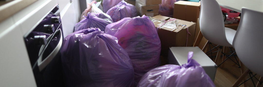 Kitchen is full garbage bags and cardboard boxes. Hings are packed in packages and boxes for moving to other housing. Old things collected for garbage disposal. General cleaning in kitchen