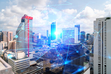 Obraz premium Abstract technology icons hologram over panorama city view of Bangkok, Asia. The concept of people networking and connections. Double exposure.