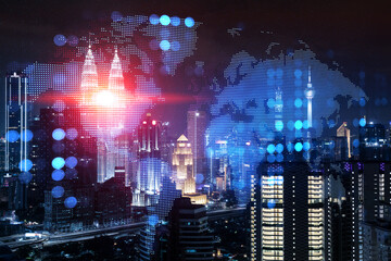 Hologram of Earth planet map on night panoramic cityscape of Kuala Lumpur, Malaysia, Asia. The concept of international companies in KL. Multi Exposure.