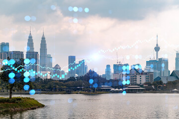 Glowing FOREX graph hologram, aerial panoramic cityscape of Kuala Lumpur at sunset. Stock and bond trading in KL, Malaysia, Asia. The concept of fund management. Double exposure.