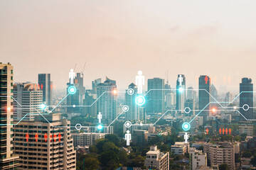 Naklejka premium Social media icons hologram over panorama city view of Bangkok, Asia. The concept of people networking and connections. Double exposure.
