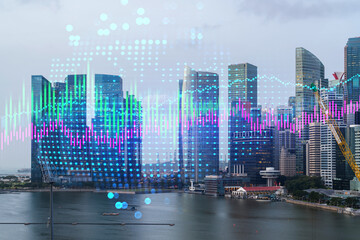 Financial stock chart hologram over panorama city view of Singapore, business center in Asia. The concept of international transactions. Double exposure.