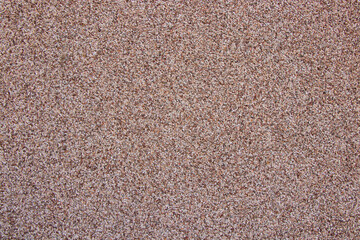 Facing of the house from decorative plaster. Background from small multi-colored stones. Stone textured background.