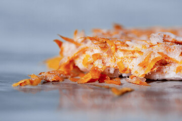 Frozen grated carrots on a marble table close-up. Storage of frozen food. Frozen product.