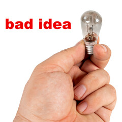 Bad idea. A hand holds an old blown incandescent lamp.