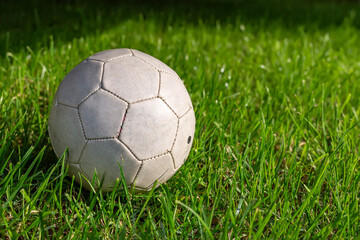 Football, sports. A fine green meadow with a soccer ball on it