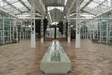 Interior of a beautiful greenhouse built with white steel and different ornamental elements. Nursery of the Matadero in Madrid, Spain.
