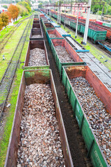 Odessa, Ukraine - October 13, 2016: Heavy industry - coal, metal, square iron pipe is transported in railway freight wagons of the train yard
