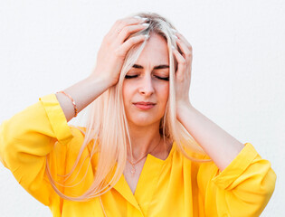Woman with a headache on white background