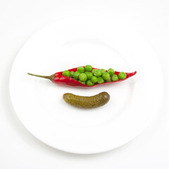 salad of pickled and pickled peas, cucumber and red pepper on a white plate.