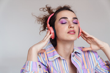 Image of relaxed woman using wireless headphones with eyes closed