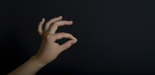 woman with hands on black background