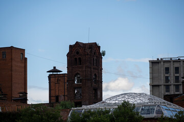 old red brick factory as a medieval fortress against a blue sky with clouds