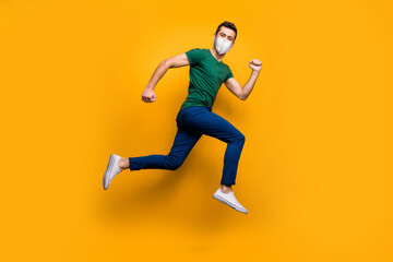 Fototapeta na wymiar Full length body size view of his he attractive sporty healthy guy wearing safety n95 mask jumping running marathon stop mers cov influenza pandemia isolated vibrant yellow color background