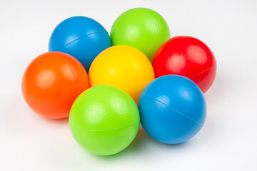 Colored plastic balls on white background