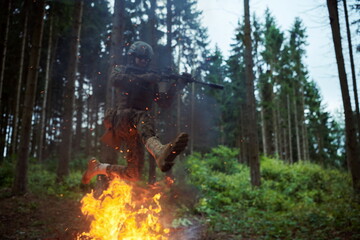 Soldier in Action at Night jumping over fire
