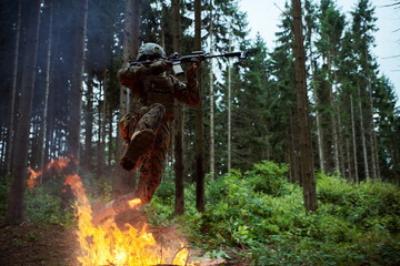 Soldier in Action at Night jumping over fire