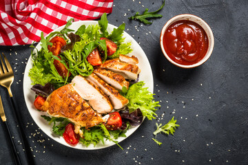 Grilled chicken with fresh salad at black.