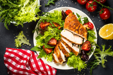 Grilled chicken with fresh salad at black.
