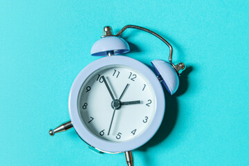Simply minimal design ringing twin bell vintage classic alarm clock Isolated on blue pastel...