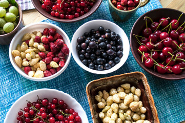 Ripe berries in plates, top view