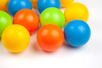 Colored plastic balls on white background