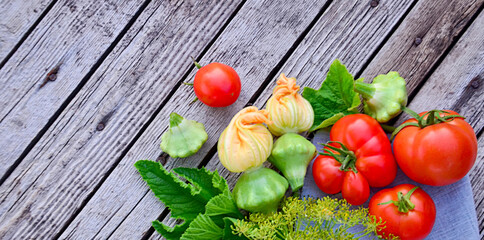 farm tomatoes and squash with flowers on wooden old photo