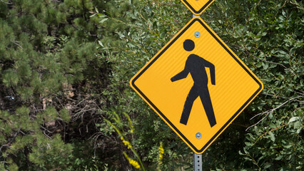 Pedestrian crossing yellow street sign.