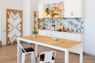 Fashionable spacious apartment with a stylish design in green, grey and white pastel colors with big window and decorative walls. bedroom and kitchen space