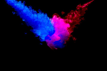 A cloud of red and blue paint released into clear water. Isolate on a black background.