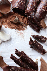 Chocolate pastille with coconut on a white background. Flat layout. Copy of the space.Top view.