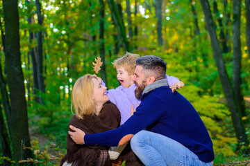 Happy family. Happy young couple with kid outdoors. Family with boy. Young parents and children having picnic and relaxing together on an autumns sunny day. Happy family outdoors.
