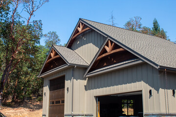 Large garage bays with arches and board and batten siding.