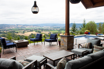 Backyard hilltop patio with a beautiful view overlooking a winery valley. - obrazy, fototapety, plakaty