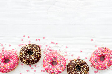 Top view of colorful glazed donut swith sprinkles, copy space