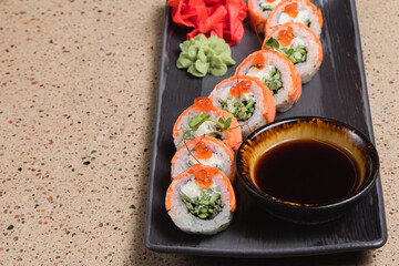 Sushi. Various rolls on a plate with soy sauce.