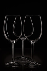 Group of three glass for wine on black backgroung. Close up high contrast view.