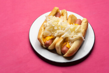 Montreal hot dog with cabbage on pink background