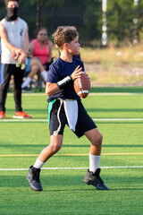 Young athletic boy playing in a flag football game