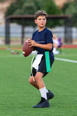 Young athletic boy playing in a flag football game © Joe