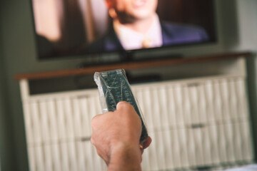 Covid-19 sanitize and extra cleaning precautions in a hotel room in Orlando Florida tv is remote covered with plastic wrap 