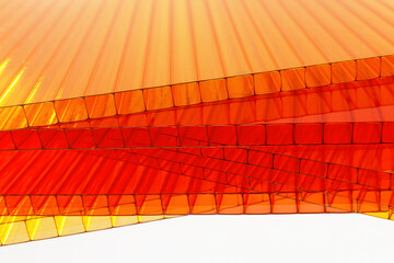 Orange, yellow and red color Polycarbonate Sheet with waterdrops. Acrylic Plastic glass isolated on white background