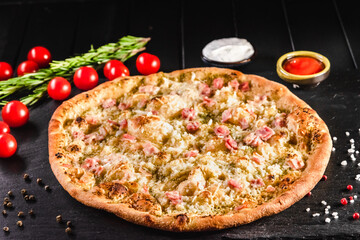 Traditional Italian focaccia among tomato and spices on a dark background, studio light. Traditional food concept